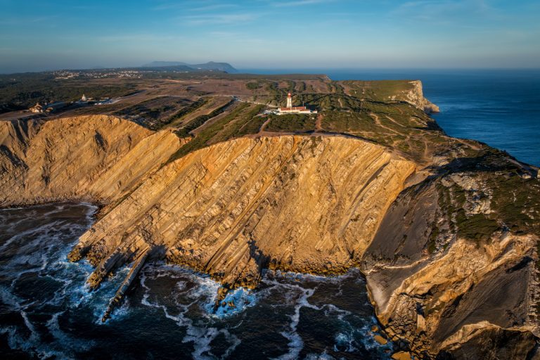 Aerial drone view of lighthouse on Cabo Espichel cape Espichel on Atlantic ocean